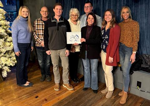 Retiring downtown director Laura Lachance is presented with 3D printed image of downtown Murphy. From left are Victoria Ivie, Barry McClure, Chad Simons, Gayle Walker Stansell, Tim Radford, Lachance, Sara Posey Davis and Casey Covington Kerr.