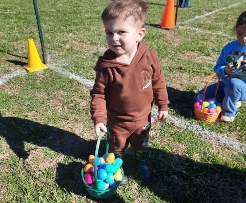 Asher Garcia appeared proud of his basket of goodie-filled eggs. The tot perused the brightly speckled field with wide eyes and a big smile at Shepherd of the Mountains Church in Murphy. – Photos by Anngee Quinones-Belian/Staff Correspondent 