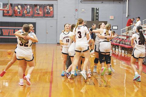 Cannon Crompton/sports@cherokeescout.com The Andrews girls varsity basketball team celebrates its win over Summit Charter on Monday night.