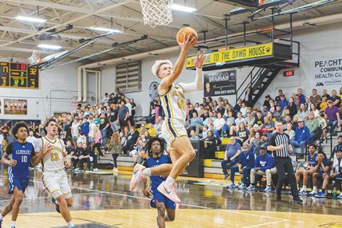 Cannon Crompton/sports@cherokeescout.com Grayson Hall of Murphy takes to the air to make a layup against Albemarle on Thursday night.