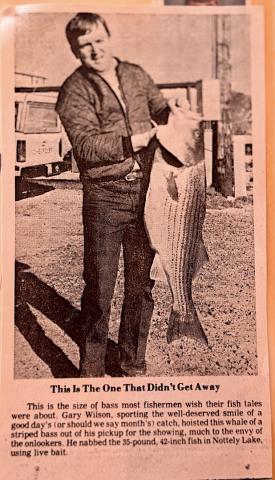 Gary Wilson is holding the 35-pound striper he caught 40 years ago with the caption, “This is the one that didn’t get away,” published in the Cherokee Scout.