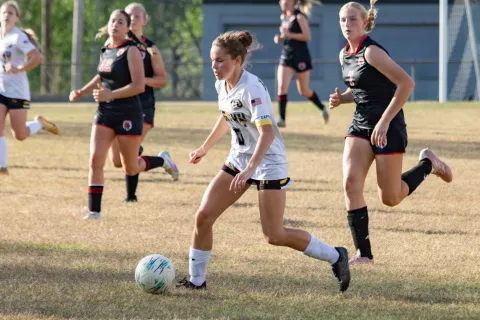 Halie Hill runs down with the field with the ball against Andrews on April 13.