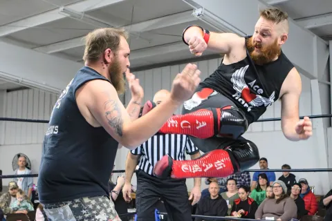 Ace Hart (right) lands a kick on Kevin Seiber at ACWF’s February show.