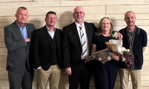 Joining Maria Hass (center) on March 26 were brothers Joe Wood and Tim Wood; husband, Eric Hass (from left); and one of her sons, Jacob Martinez (right).