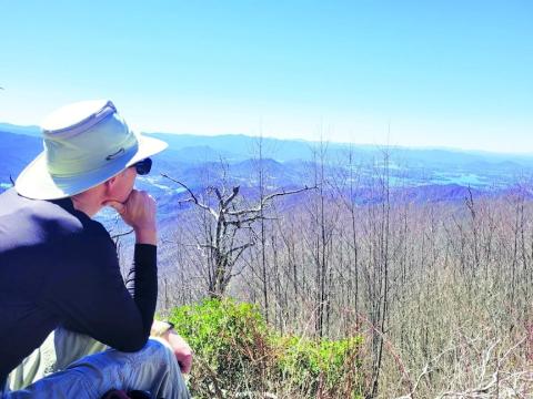 Clay County resident Philip Moore looks out over Lake Chatuge from Boteler Peak, also known as Shooting Creek Bald.