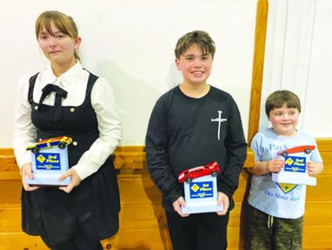 Cherokee County Pit Crew winners of the Pinewood Derby are Levi Anderson, first place; Felicia Kimmel, represented by son Korbin, second place; and Alexa Ceberek, third place.
