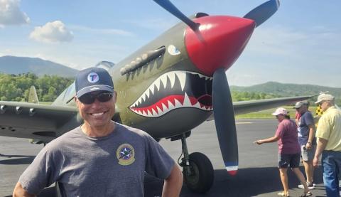 Thom Richard of Warbird Adventures flashes a wide grin next to his Warhawk as crowds marvel at the plane at the April 18 Welcome Home event at Western Carolina Regional Airport. He said the plane is always his most popular attraction at shows. Richard operates a flight school in Ninety-Six, S.C. 