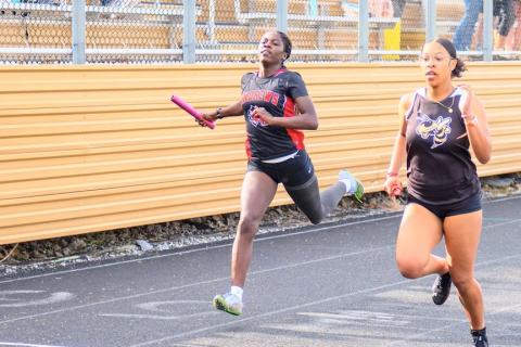 Juliet Holloway (left) of Andrews competes in the 4x200-meter relay at Hayesville on April 1.