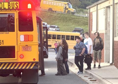 Students board a transfer bus at Murphy High School in this 2024 photo.