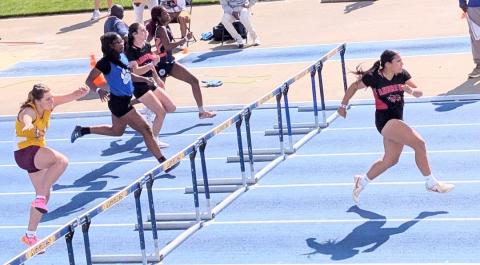 Kaiya Ellis (right) of Andrews leads the 1A girls 100-meter hurdles during the preliminary qualifying run on Thursday at N.C. A&T in Greensboro.