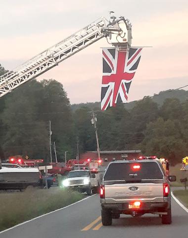 A ceremonial flag raising honored Alan Andrews who was born in London.