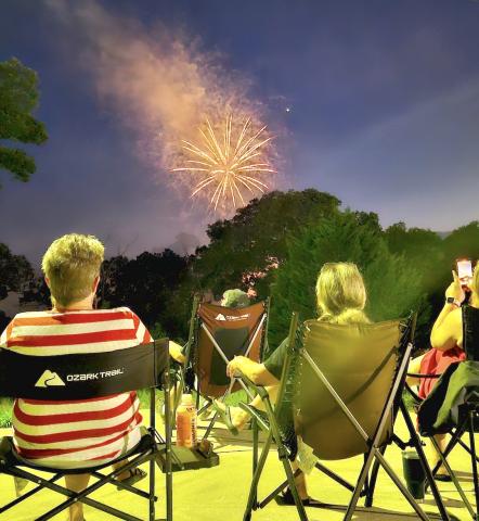 Locals and visitors like Ben and Becky McDonald of Hanging Dog and Sandy and Sam Graves of Robbinsville enjoyed the fireworks throughout downtown. Photo by Stacy Van Buskirk/Cherokee Scout