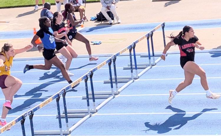 Kaiya Ellis (right) of Andrews leads the 1A girls 100-meter hurdles during the preliminary qualifying run on Thursday at N.C. A&T in Greensboro.