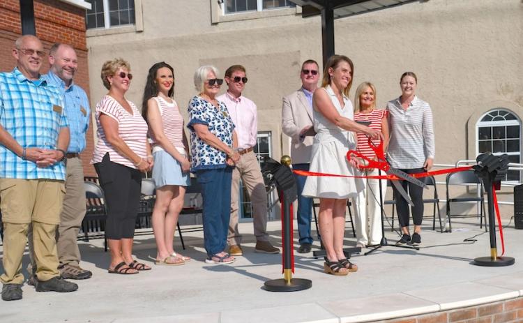Laura Lachance, retired executive director of Murphy's Main Street Program, cuts the ribbon dedicating the new Downtown Square and Stage.