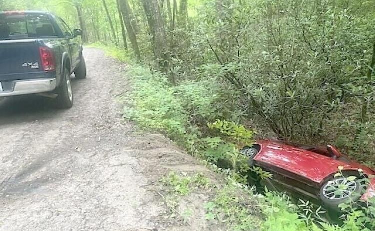 An elderly man lay trapped inside his vehicle on June 1, after it ran off a roadway and into the woods. Emergency responders quickly arrived at the scene.