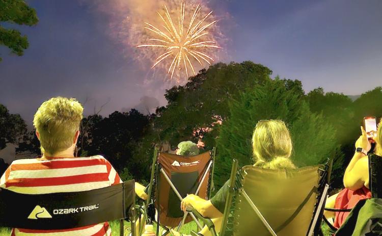 Locals and visitors like Ben and Becky McDonald of Hanging Dog and Sandy and Sam Graves of Robbinsville enjoyed the fireworks throughout downtown. Photo by Stacy Van Buskirk/Cherokee Scout