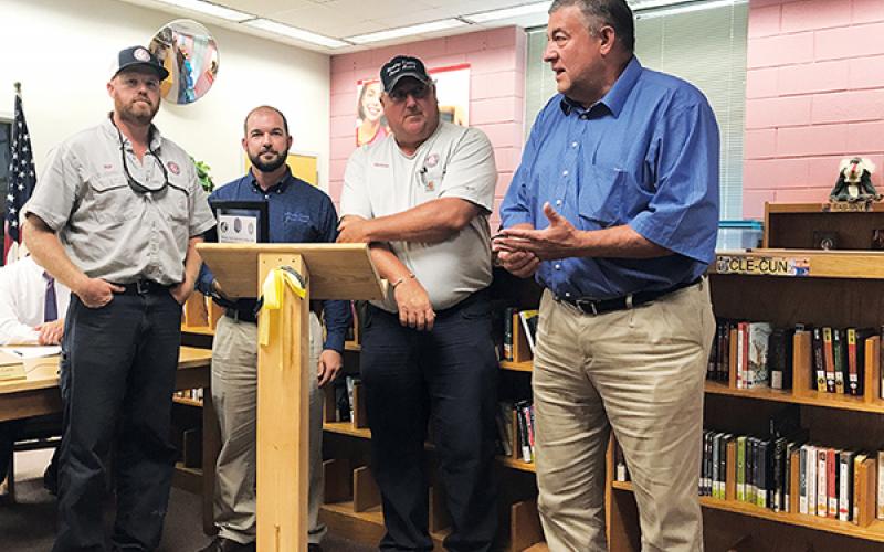 Murphy Electric Power Board employees (from left) John Hall, Chris Raper and Justin Coker, along with President Larry Kernea, accept a certificate of appreciation Thursday for their efforts in working on the playground at Murphy Elementary School.