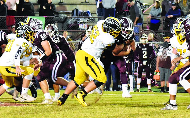 Murphy lineman Colby Stalcup records one of his two sacks Friday night during the Bulldogs’ first win against the Swain Maroon Devils in Bryson City since 2005. Photo by Noah Shatzer