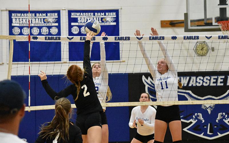 Andrews' Kinsleigh Dartez (2) looks to kill the ball with Hiwassee Dam's Ashlyn Weaver and Kayley Sells looking to block.