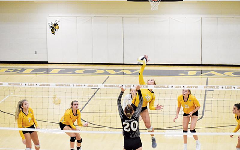 Hayesville’s Halle Johnson (20) could use a hand as Murphy’s Grace Nelson looks for a kill. Photo by Noah Shatzer