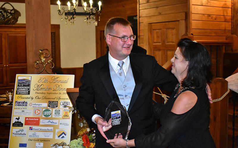 Tim Radford, owner of WKRK radio, smiles after receiving the Cherokee County Chamber of Commerce’s 2019 Citizen of the Year award from chamber Executive Director Sherry Raines on Thursday night.