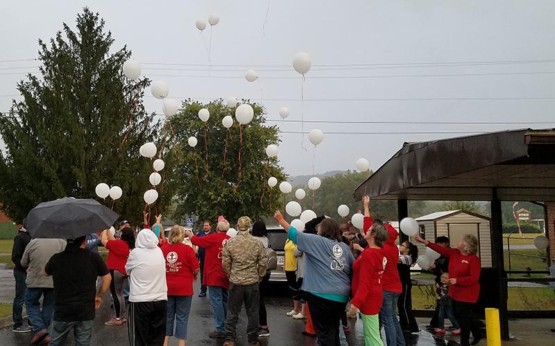 After completing the Highways N Hedges walkathon, eating a meal and coming to together in prayer, participants released balloons filled with names of those battling substance abuse.