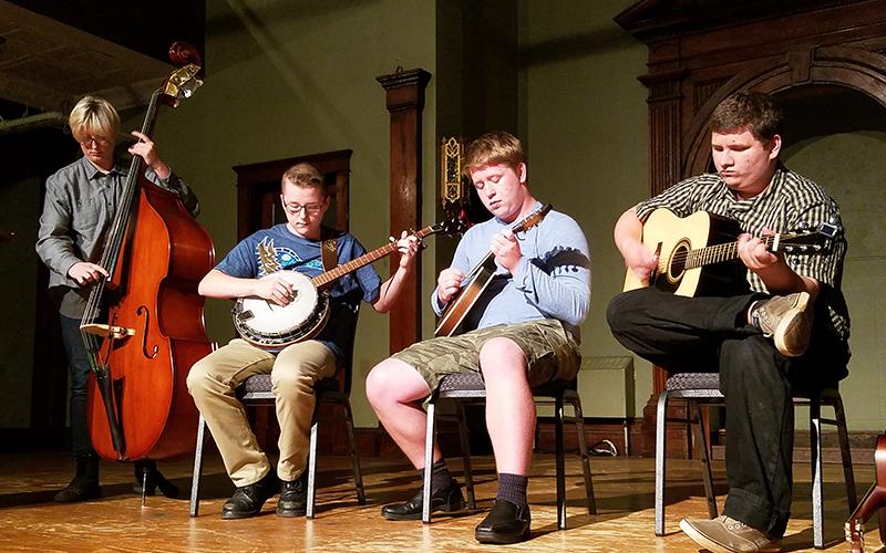 Junior Appalachian Musicians Grace Allen, Jaeden Love, Billy Allen and Nathan Perrine perform folk music as the finale for Writers & Wine on Saturday night.