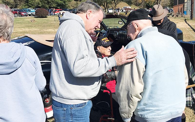 Murphy Mayor Rick Ramsey talks with World War II veterans Walter Kerr (right) and Charlie Raper (background) during the festival at Konehete Park.
