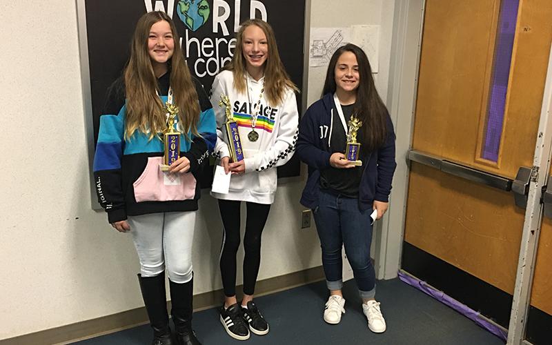 A happy Hailie Madlock (center) took home the first-place trophy Thursday morning during the 14th annual Cherokee County Middle Schools Spelling Bee at Martins Creek School. Fellow Martins Creek student Alexis Tighe (left) finished second, while Isabelle Gladson of Ranger (right) took third.