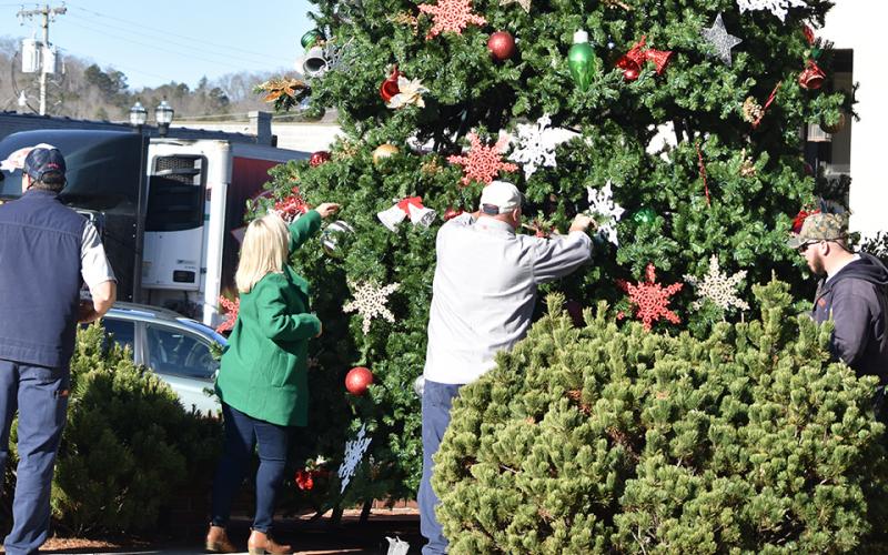 Cindy Chastain directs as Town of Murphy and Murphy Electric Power Board employees place a section of the new Christmas tree Thursday morning. Photo by Samantha Sinclair