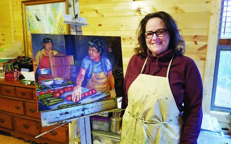 In her home studio, Cynthia Pollett shows "Tomato Cooks," one of her paintings of daily life in China. Photo by Samantha Sinclair