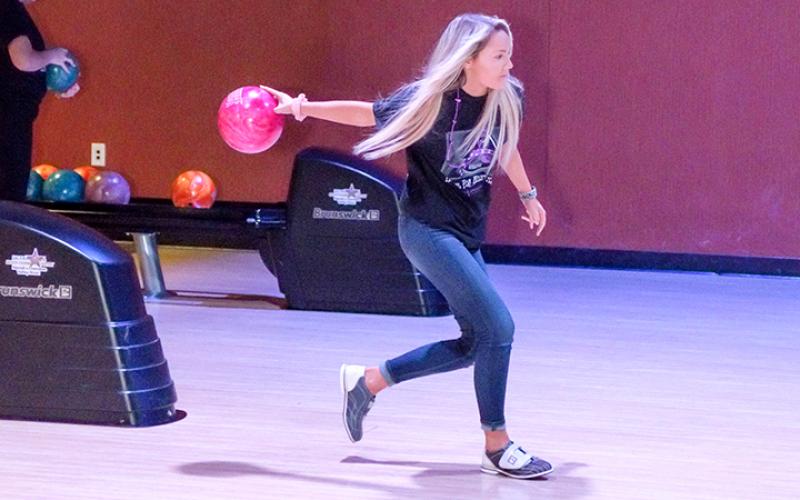 Local residents who were bowling to help Big Brothers Big Sisters of Cherokee County really got into the games Saturday. Photo by Sam Jokich