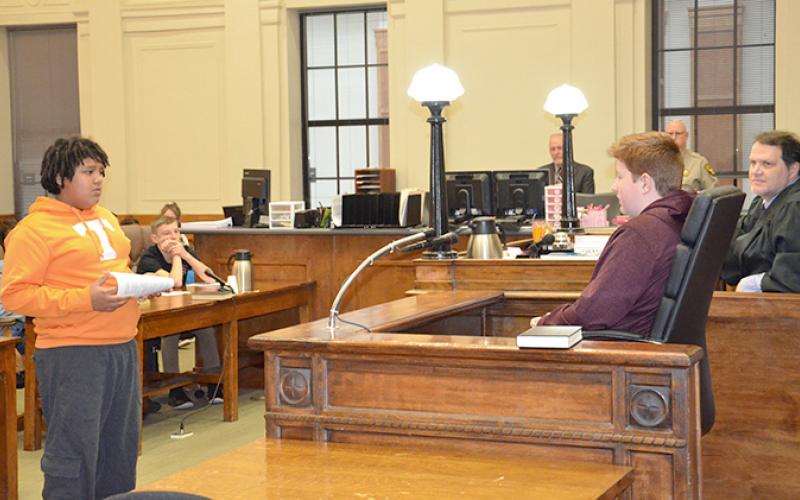Antonio Hernandez (defense attorney) questions William Wood as Darrel Curtis (witness for the defense) during a mock trial based on the book The Outsiders. Photo by Penny Ray