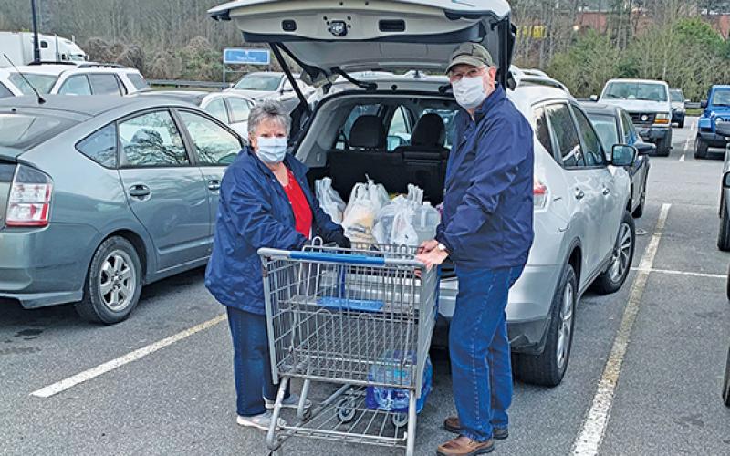 Richard and Mildred Pullium are taking precautions, but like most people still needed to go shopping Thursday. Photo by Sam Jokich