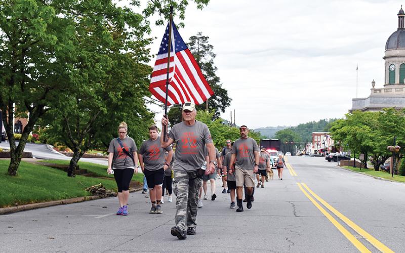 U.S. Air Force veteran Mark Narcowitz leads the procession of 22 Hump walkers down Peachtree Street in Murphy on the morning of May 23. Photo by Noah Shatzer
