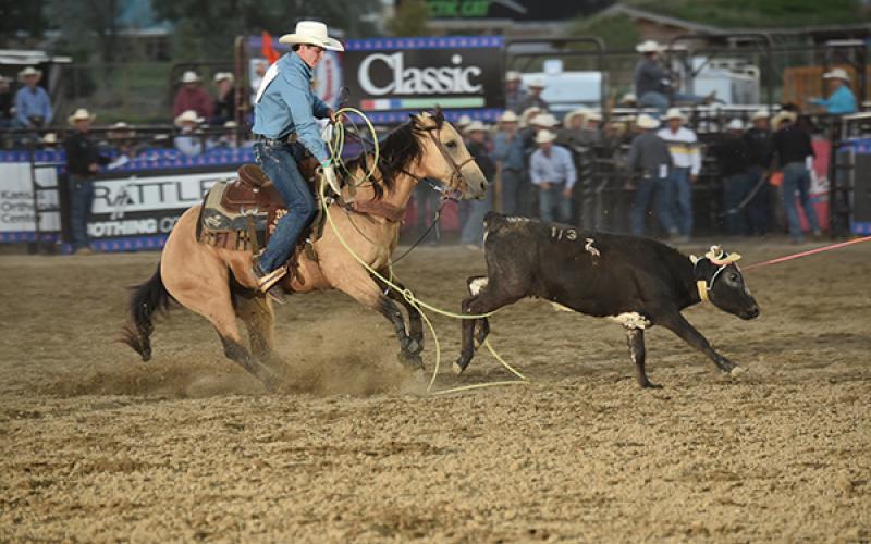 Acentric Rodeo/Contributing Photographer: Marble’s Trevor Boatright ropes the hind legs of an escaping calf during the team roping competition during the National High School Finals rodeo in Guthrie, Okla.  