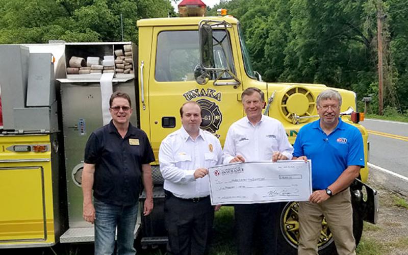 From left are state Rep. Kevin Corbin, Unaka Fire Chief Tylor Dockery, Commissioner Mike Causey and N.C. Firefighter Association financial director Dean Coward. Photo by Samantha Sinclair