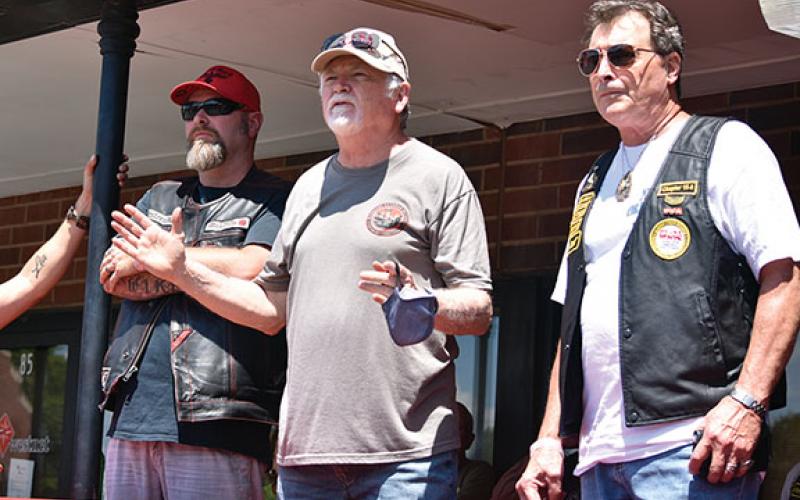 Local Toys for Tots coordinator Don Slifer thanks participants for helping Toys for Tots, as Corey Wike of Western NC Wingmen and Bruno Coltri of Combat Veterans Motorcycle Association stand beside him. Coltri provided the opening prayer for the event. Photo by Samantha Sinclair