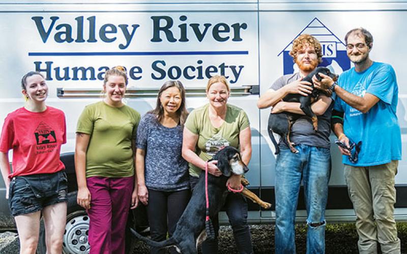 Sam Jokich/For the Cherokee Scout Workers at the Valley River Humane Society’s animal shelter off U.S. 19/74 in Marble include (from left) Hannah Christopher, Hailey Henson, Carol Reagan, Caleb Atherly, Kirsty Waller (one of the managers) and Scotty Derreberry. The larger dog is Abe, the puppy is Drew.