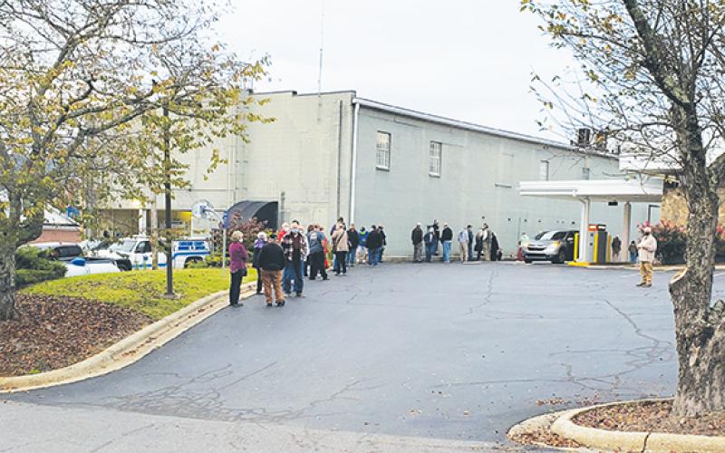 As early voting began Thursday morning, the line to vote wrapped along the side of the Cherokee County Courthouse Annex in downtown Murphy and along the edge of the parking lot for PNC Bank next door. Photo by Samantha Sinclair