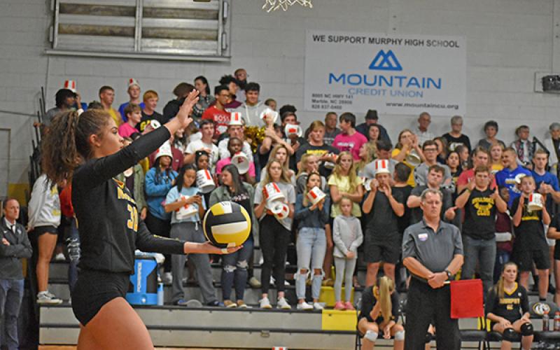 Lady Bulldogs outside hitter Grace Nelson lines up a serve in front of Murphy’s student section. Limits on attendance for this year’s volleyball season are expected, but guidelines for spectators have yet to be announced by the state.