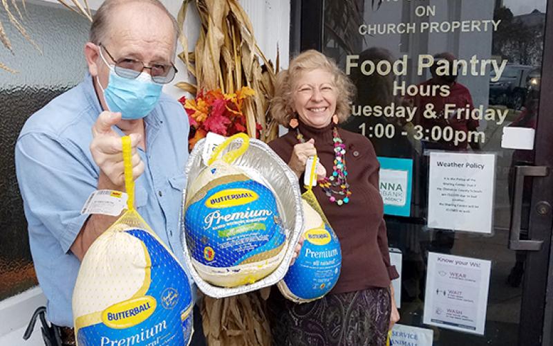 Steve Beavers and his wife, Patricia Rife-Beavers, are shown delivering gifts of frozen turkeys to the Sharing Center food pantry given in honor of her father, Ed Rife, who died recently but had been a volunteer worker at the center well into his 80s. 