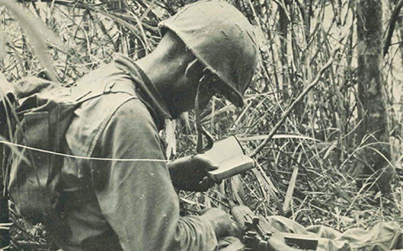  U.S. Marines veteran Richard Ferris (right), who lives in Murphy today, reads his Bible while serving in the jungles of wartime Vietnam from 1966-68.