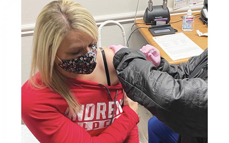 Lindsey Roberts, a nurse at the Cherokee County Health Department, receives the first COVID-19 vaccination in the county. Nurse Misty Postell administered the vaccine on Dec. 23.