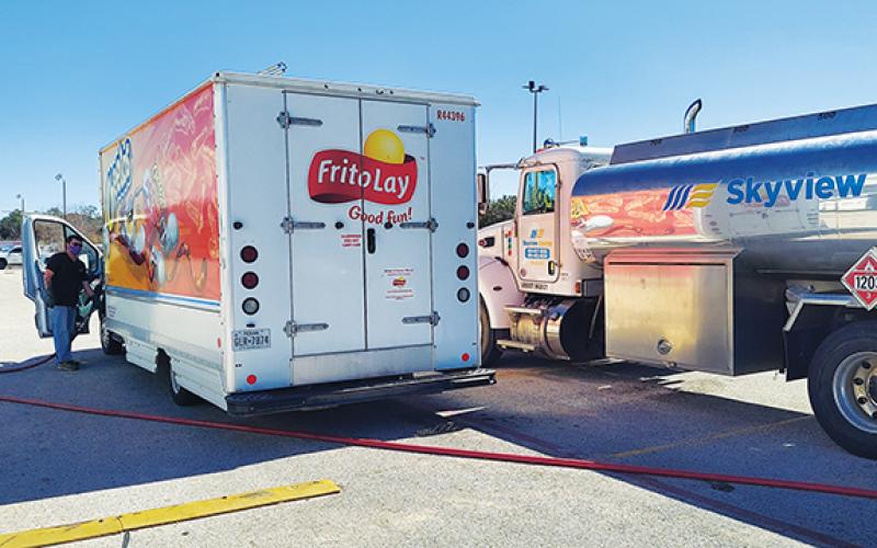 Skyview Energy driver Allen Crisp fills a Frito-Lay employee’s vehicle in Pharr, Texas.