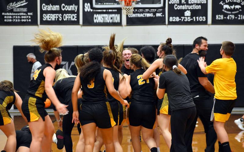The Murphy Lady Bulldogs celebrate after their Elite Eight victory over Robbinsville.