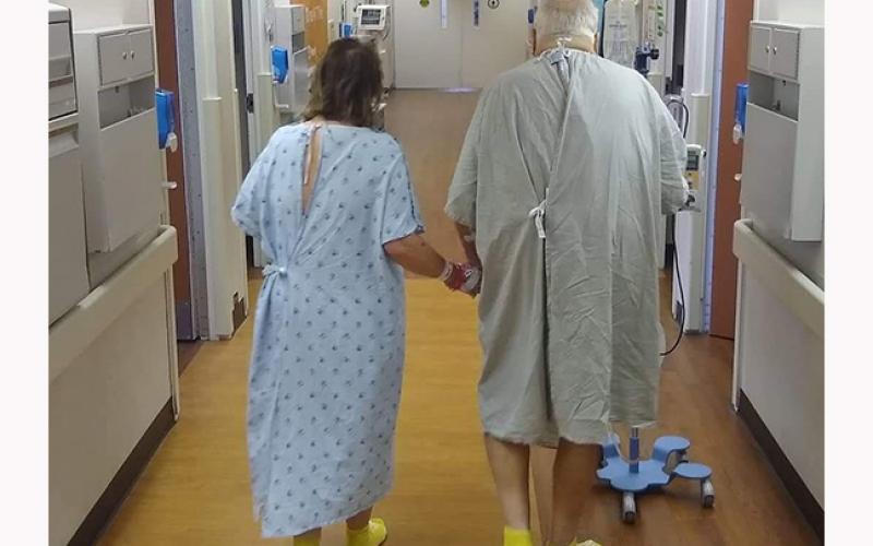 Jacky Egli (left) walks the halls of the Piedmont Transplant Center in Atlanta with her husband, Rich Egli, after giving him a kidney as a live donor.