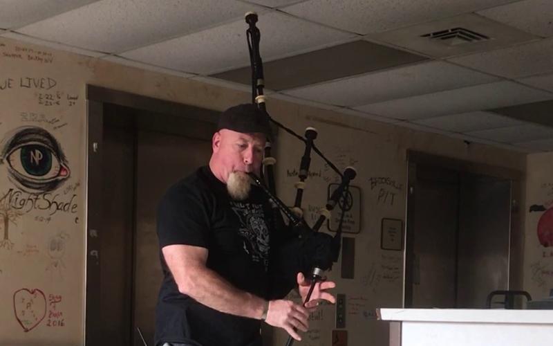 Bill Higgins plays the bagpipes to stir up the spirits for the Cherokee County Paranormal Society.