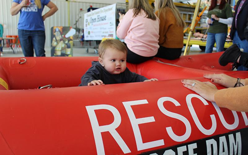 Cade Matheson plays in a rubber rescue boat during Hiwassee Dam’s open house. 