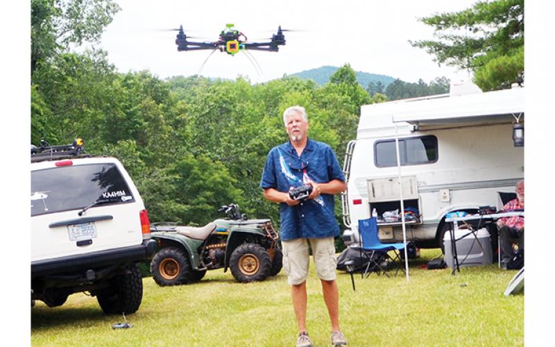Carl Saylor controls his sophisticated drone Saturday during the Western Carolina Amateur Radio Society’s annual Field Day at Fields of the Wood.